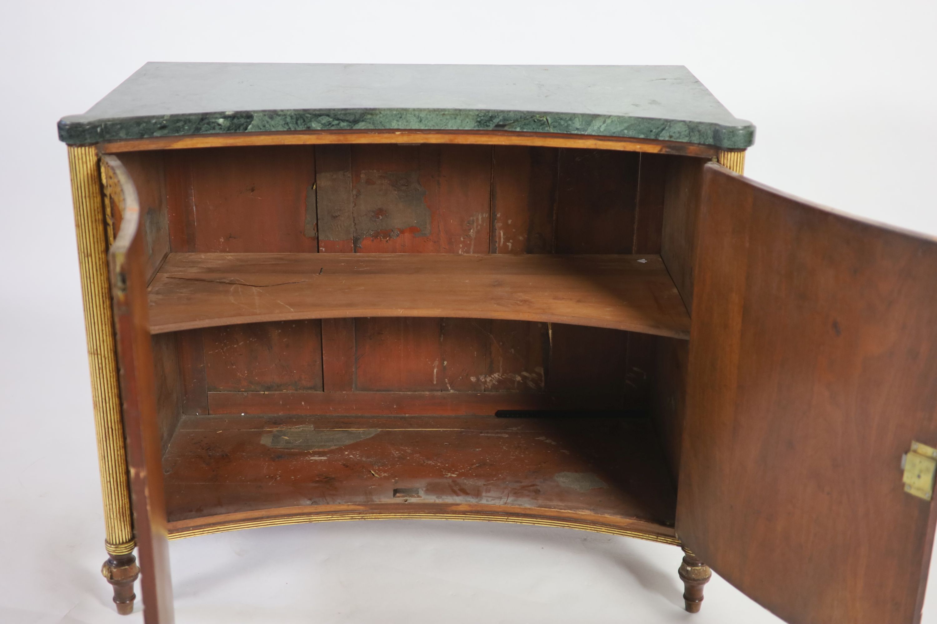 A Regency parcel gilt rosewood concave front side cabinet W.106cm D.52cm H.87cm